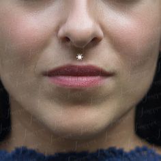 a woman with a nose piercing on her nose