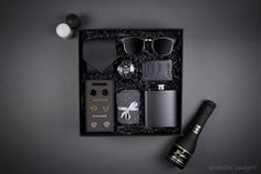 an assortment of men's accessories in a black box