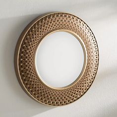 a round mirror hanging on the wall