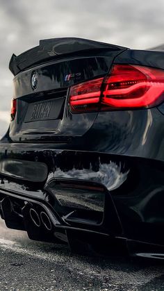 the rear end of a black bmw car