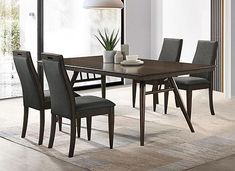 a dining room table and chairs in front of a large window with a potted plant on it