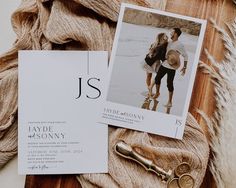 a couple's wedding stationery is laid out on top of a blanket and some other items