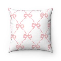 a white pillow with pink bows on it