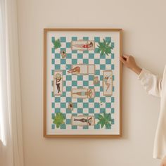 a woman standing next to a wall with a checkered board on it