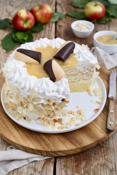 a piece of cake with white frosting and chocolate on top sitting on a plate