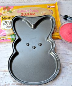 an easter bunny cookie pan next to some candy