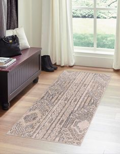 a large rug on the floor in front of a window