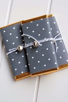 two gray and white dotted notebooks tied with twine