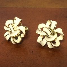 "Vintage Coro Signed, Silver Tone, White Enamel, Floral, Screw Back, Clip-on Earrings, 1950's Beautiful and unique earrings, looks like a ribbon tied into a flower shaped bow. They measures about 7/*8\" x 1\" long. Excellent vintage condition. Screw back hardware intact and secure with no notable issues. PLEASE SEE PHOTOS FOR MORE DETAILS, AND MESSAGE ME WITH ANY QUESTIONS." White Vintage Earrings, White Vintage Round Earrings, Vintage White Round Clip-on Earrings, Retro White Clip-on Jewelry, Retro White Earrings For Formal Occasions, White Retro Earrings For Formal Occasions, White Retro Formal Earrings, Vintage White Clip-on Earrings For Anniversary, White Vintage Clip-on Earrings For Anniversary