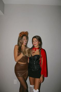 two women dressed in costumes posing for the camera