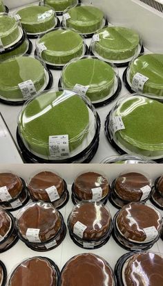 there are many pies on display in the store and one has green frosting