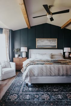 a large bed sitting in a bedroom on top of a blue rug