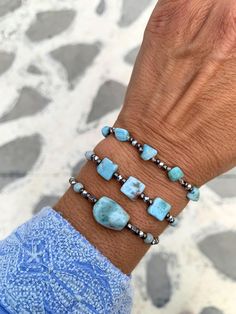 These stunning bracelets feature genuine sky blue Barahona Larimar nuggets, renowned for their captivating blue hues reminiscent of the tropical color of Caribbean sea!  ▽▲Details▽▲ ⭐AAAA sky blue Larimar nuggets 16-17mm ⭐AAAA Cube rectangle nuggets 7mm ⭐AAAA Freeform nuggets 5mm ⭐Smooth polish finish ⭐Silver mineral graphite beads (tarnish free) ⭐Clever fastening to secure perfect fit ⭐Adjustable length ⭐Allergy free/Nickel free ⭐Waterproof use ⭐Handmade excellency Larimar is a rare blue copper Silver Bracelets With Amazonite And Natural Stones, Silver Amazonite Bracelet As Gift, Silver Amazonite Bracelet For Gift, Handmade Turquoise Aquamarine Bracelets, Turquoise Aquamarine Beaded Bracelets With Natural Stones, Turquoise Aquamarine Beaded Bracelets As Gift, Aquamarine Turquoise Bracelet For Healing, Spiritual Aquamarine Turquoise Bracelets, Spiritual Turquoise Aquamarine Bracelets