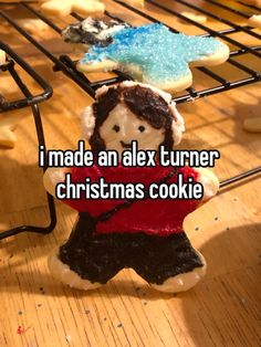 some cookies that are on a rack with the words made an alex turner christmas cookie