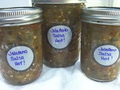 three jars filled with food sitting on top of a white towel