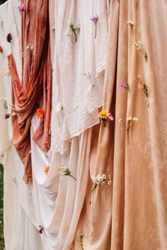 many different colored dresses hanging on a line