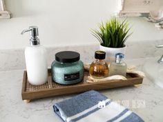 a bathroom sink with soap, lotion and other items on it