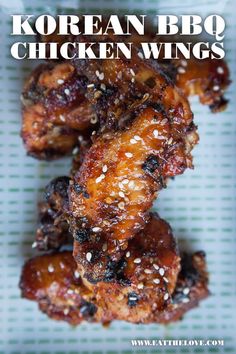 korean bbq chicken wings with sesame seeds on the side and text overlay that reads, korean bbq chicken wings