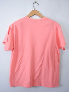 One vintage 1990's plain peach pink tee shirt, men's size small * Crew neckline. * Plain shirt. * Color scheme: pink with peach tones / salmon. | CONDITION | A+. Gently used vintage item. | BRAND | Fruit of the Loom. Made in Honduras. | SIZE | Marked as a child's Large (USA). Fit would be similar to a men's Small or XSmall. PLEASE compare the measurements below to a similar item that fits you for the best sizing! ~ Garment laying flat. Double measurements where applicable. ~ Shoulder width: 15.5 Peach Short Sleeve T-shirt For Summer, Casual Peach Short Sleeve T-shirt, Casual Heather Peach Short Sleeve T-shirt, Heather Peach Cotton Short Sleeve T-shirt, Heather Peach Short Sleeve Cotton T-shirt, Heather Peach Relaxed Fit Crew Neck T-shirt, Heather Peach Cotton T-shirt, Peach Graphic Tee Short Sleeve, Peach Graphic Tee With Short Sleeves