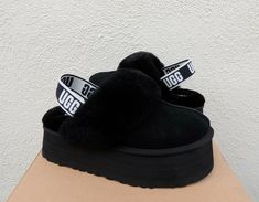 UGG FUNKETTE BLACK FLUFF SLIPPER PLATFORM SANDALS ~ NEW IN BOX WOMEN'S SIZE US 8/ EUR 39/ UK 6 ~ FITS US 8-8.5/ EUR 39-39.5/ UK 6-6.5  STYLE # 1113474  COLOR: BLACK ~MY ITEMS ARE ALWAYS AUTHENTIC, PLEASE SEE MY TRUSTED FEEDBACK Both indoor and outdoor use Suede uppers with sheepskin collar Sheepskin lining Sheepskin insole Stretch UGG logo heel strap 2 " EVA sole ( Fluffy insole add's a bit extra height) Please see the pictures for more detail Inside size tag and box upc have been marked to prev Ugg 2022, Ugg Funkette, Surfer Shoes, Pretty Sneakers, Air Shoes, Black Uggs, Black Slippers, Nike Air Shoes, Ugg Black