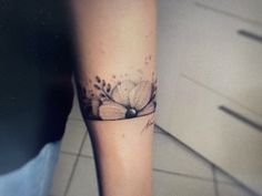 a woman's leg with a tattoo on it that has a flower in the center