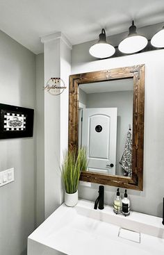 a bathroom with a sink and mirror in it