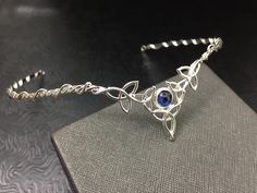 I've fabricated a Celtic Irish wedding bridal circlet, in sterling silver, featuring 5 Trinity Knots with an 8mm round cabochon Of your choice in the drop down menu. This Celtic tiara is lovely, slightly Bohemian and sophisticatedly elegant. This wedding circlet can be used for a wedding accessory, or any costuming event, such as cosplay or a Renaissance fair! Please allow me 5 business days to fabricate a new headpiece for you! **For matching earrings: https://www.etsy.com/listing/42139307/ster Elegant Adjustable Jewelry For Ceremonies, Silver Hand Forged Jewelry For Wedding, Hand Forged Silver Wedding Jewelry, Traditional Hand Forged Wedding Jewelry, Traditional Hand Forged Jewelry For Wedding, Handmade Silver Jewelry For Marriage, Adjustable Hand Set Silver Necklaces, Adjustable Hand Set Silver Necklace, Silver Hallmarked Jewelry For Wedding