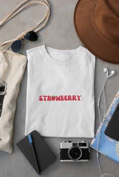 🍓Embrace the fruity vibes with our sweet strawberry short sleeve shirt! Whether you're a fan of strawberry picking, a fruit lover, or just enjoy a pop of color in your wardrobe, this shirt is the perfect choice. ✨Welcome to the Magic Churro Boutique! Creating magic you can wear. ✨ We only create products we'd wear ourselves. If you're looking for fun, funky, retro, or anything in-between, you're in the right place.  👚SIZING & COLORS👚 Please refer to size chart on the listing photos in every listing for a detailed sizing chart with measurements. Since everything is made to order, sizing issues will not be refunded. Colors of the text & design and/or color of the shirts/sweatshirts can vary a little from the photo shown, due to lighting, printing, and/or computer/phone screens. ✈️PROCESSI Sweet Short Sleeve Tops With Fruit Print, Cotton T-shirt With Strawberry Print, Cotton Short Sleeve T-shirt With Strawberry Print, White Relaxed Fit T-shirt With Strawberry Print, Sweet Cotton Tops With Fruit Print, Trendy Red T-shirt With Strawberry Print, Cute Crew Neck T-shirt With Fruit Design, Casual White Tops With Fruit Design, Casual White Top With Fruit Design