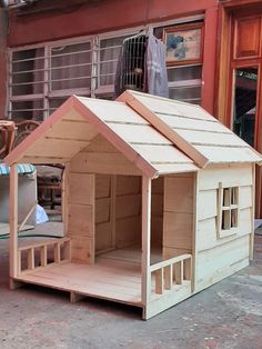 a dog house made out of plywood and wood