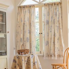 a table with a basket on it in front of a window