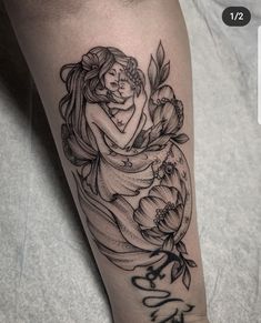 a tattoo on the leg of a woman with flowers