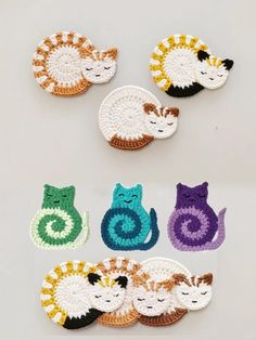 crocheted cats and kittens sitting on top of each other in different colors