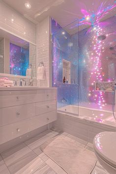 a bathroom with pink and blue lights on the shower wall, tub and sink area