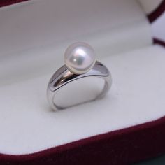 Introducing our 9-10mm Freshwater Pearl Ring, a modern and simple design that's perfect even as a wedding ring. Available in both gold and silver, this ring features a stunning white or purple pearl, exuding classic elegance with a contemporary twist. Its flexible size ensures a comfortable, adjustable fit. This piece is a versatile and chic choice for everyday wear or special occasions. This popular ring design features AAAA quality, round freshwater pearls measuring 9-10mm. Material: Freshwate Modern White Pearl Ring For Anniversary, Minimalist Pearl Rings For Formal Occasions, Modern Pearl Ring For Formal Occasions, Modern Pearl Rings, White Gold Akoya Pearl Ring As Gift, Modern Pearl Rings For Anniversary, Classic White Gold Pearl Ring As A Gift, Classic White Gold Pearl Ring For Gift, Classic White Gold Pearl Ring Gift