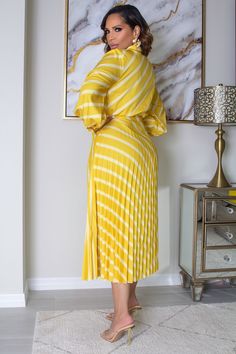 The Adriana Striped Belted Shirt Dress exudes elegance with its striped pattern and belted, pleated design. The wrap neckline and collar add a tasteful touch, and the long sleeves and regular fit provide a sophisticated silhouette. This dress boasts a high waistline and pleated hem for a figure-flattering look. Crafted from non-stretch fabric, this dress also comes with a belt for added style. 100% Polyester Model is wearing size small Please allow 3-5 business days to process and ship. Product Measurements in cm : Size US Shoulder Bust Waist Size Hip Size Length Sleeve Length Bicep Length Cuff S 4 39 92 72 106 123 60 34 21 M 6 40 96 76 110 124 61 35.2 22 L 8/10 41.5 102 82 116 125.5 62.5 37 23.5 Pleated Striped Dresses For Spring, Chic Striped Belted Dress, Chic Striped Long Sleeve Midi Dress, Chic Long Sleeve Dresses With Vertical Stripes, Elegant Striped Belted Dress, Elegant Yellow Pleated Midi Dress, Long Sleeve Dresses With Vertical Stripes For Work, Long Sleeve Vertical Stripe Work Dresses, Long Sleeve Vertical Stripes Work Dress