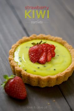 strawberry kiwi tartles on a wooden table with strawberries