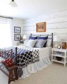 a bed room with a neatly made bed and two nightstands next to each other