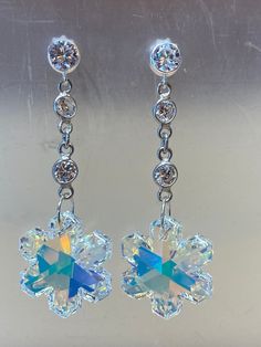 Get into the Christmas spirit with a gorgeous pair of earring made from the finest European crystals! These Christmas snowflakes sparkle and shine from every angle, and you will get compliments wherever you go. There is an AB coating on the back of the snowflake which reflect the surrounding lights and colors!  Over fifteen years of creating jewelry means that you get the highest quality of craftsmanship.  Always made with loving care using Sterling silver components.  This design is inspired by Sparkling Dangle Crystal Earrings Gift, Gift Sparkling Dangle Crystal Earrings, Crystal Flower-shaped Earrings For Gift, Crystal Clip-on Earrings As A Gift, Snowflake Sparkling Earrings For Gift, Creating Jewelry, Wedding Jewelry Earrings, Crystal Stud Earrings, Christmas Snowflakes