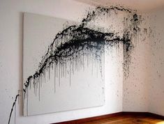 an abstract painting hangs on the wall next to a wooden floor