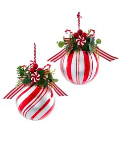 two red and white striped christmas ornaments with candy canes on them, one hanging from the ceiling