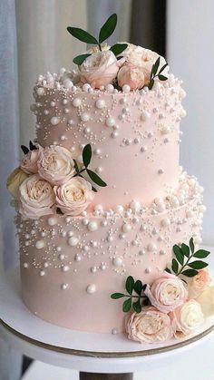 a wedding cake with flowers and pearls on top is featured in the cover of this magazine