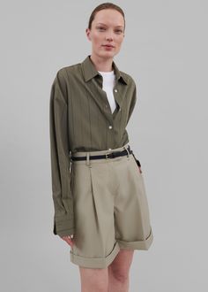 Color: Beige Midweight woven fabric Regular fit Pleated front detailing Side seam pockets Illusion back flap pockets Belt loops Zip fly Hook and bar closure Unlined 80% Polyester 20% Rayon Dry Clean By The Frankie Shop. Imported Luxury Cotton Bermuda Shorts With Belt Loops, Luxury Cotton Workwear Skirt, Luxury Casual Bottoms By Miu Miu, Luxury Structured Workwear Pants, Luxury Boyfriend Fit Bottoms For Workwear, Luxury Boyfriend Fit Workwear Bottoms, Luxury Casual Bermuda Shorts With Built-in Liner, Female Suit Shorts, Luxury Miu Miu Bottoms With Pockets