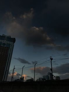 the sky is very dark and cloudy over some buildings