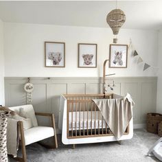 a baby's room with a crib, rocking chair and pictures on the wall