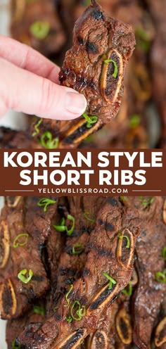 korean style short ribs with green onions on top and in the middle, being held up by a hand