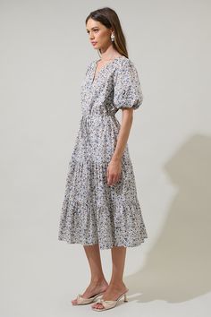 This adoreable floral midi dress will have you beaming! With its tiered skirt, draw string waist, and split neck, you're sure to look sharp on your next garden stroll. Plus, the ditsy floral print will bring a dose of charm to any daytime look. - Tiered skirt- Draw string waist- Split neck detail- Ditsy floral print- Color: Cream MultiSize + Fit - Model is 5'8" and wearing size XS- Measurements taken from size S - Chest: 20"- Length: 48" Fabric Self:100% Cotton Lining:97% Polyester 3% Spandex St Spring Tiered Dress For Daywear, Spring Floral Print Prairie Dress, Midi Length, Spring Floral Print Midi Prairie Dress, Spring Floral Print Prairie Dress Midi Length, Spring Daywear Tiered Skirt Dress, Casual Floral Tiered Skirt Dress For Garden Party, Casual Floral Tiered Dress For Garden Party, Tiered Floral Print Midi Dress For Daywear, Tiered Midi Dress With Floral Print For Daywear