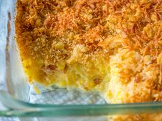 a close up of a casserole in a glass dish with crumbs on top