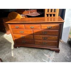 a large wooden dresser sitting on top of a cement floor