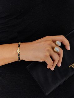 Boules in black onyx and 18kt gold distinguish this seductive jewel with a contemporary taste, entirely handmade and made unique by its brilliant clasp. Laura's advice? Combine it to the IVY bracelet (BS3-599), creating a beautiful choker! Length 18,00 cm DIAMONDS: - Weight (total): 0.25 CT - Clarity: VS - Color: G - Cut: round Natural stones: - BLACK ONYX Weight (total): 30.75 CT Elegant Onyx Jewelry With Diamond Accents, Elegant Black Diamond Bracelet, Elegant Adjustable Bracelet With Black Enamel, Luxury Adjustable Black Enamel Bracelets, Black Polished Jewelry For Everyday Luxury, Timeless Black Bangle Jewelry, Elegant Black Diamond Bangle, Luxury Jewelry With Black Diamonds, Elegant Adjustable Black Enamel Bracelets