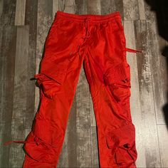 Red Streetwear Pants Eptm Cargos Size Large Casual Red Sweatpants For Streetwear, Red Bottoms For Streetwear In Fall, Red Cargo Pants For Streetwear, Red Sweatpants With Pockets For Fall, Sporty Red Pants With Side Pockets, Red Joggers With Pockets, Red Parachute Pants With Pockets For Streetwear, Urban Red Pants For Streetwear, Sporty Red Streetwear Pants